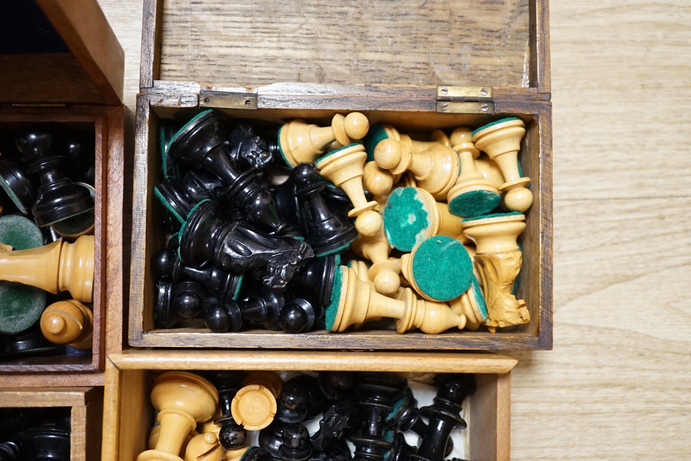 A collection of four wooden chess sets and a clock